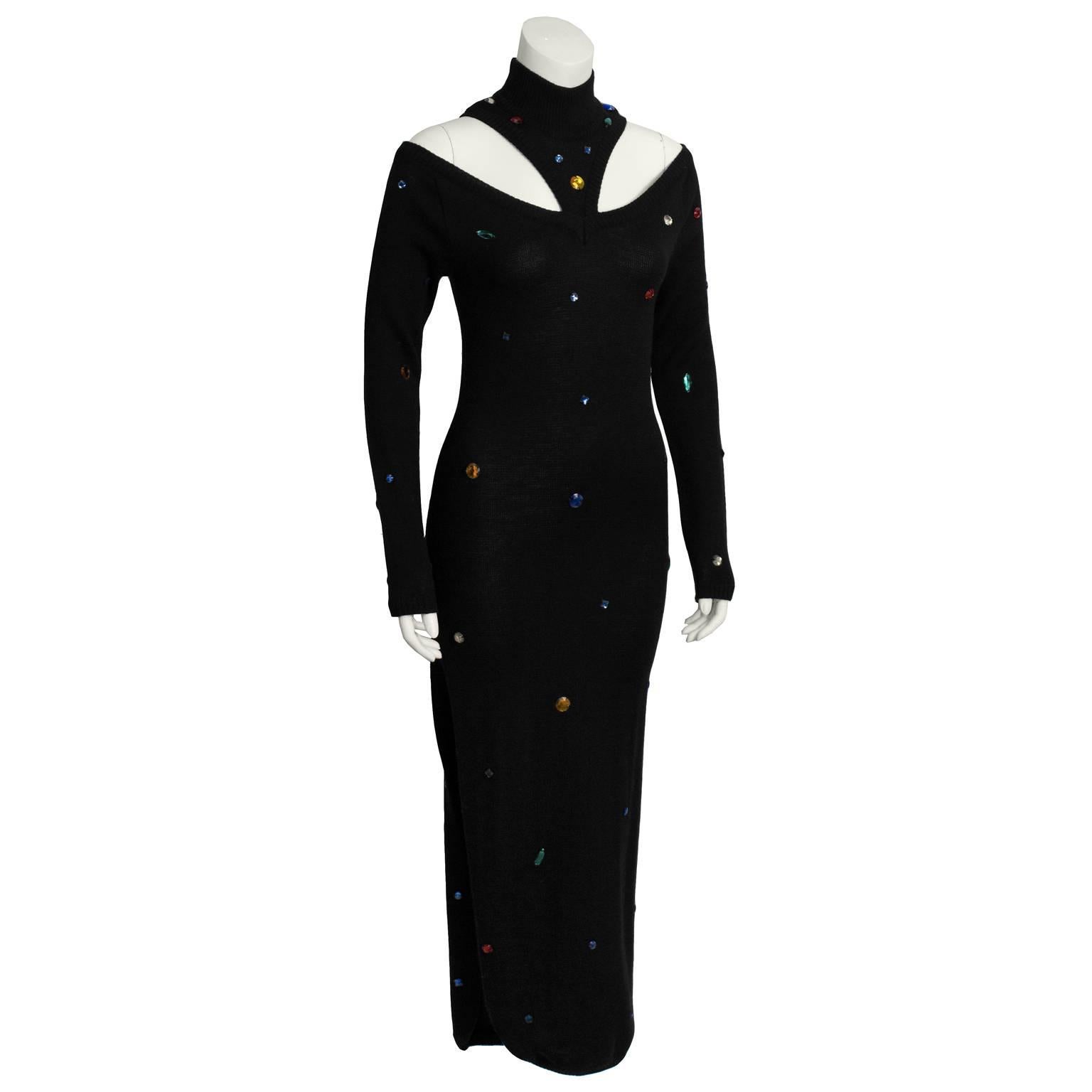 A fabulous black knit maxi dress by French designer Chantal Thomass from the 1980's. Disco fabulous black dress features a mock neck, with sexy cutout shoulders and long sleeves. Multi-colored jewels placed throughout the dress add a rock and roll