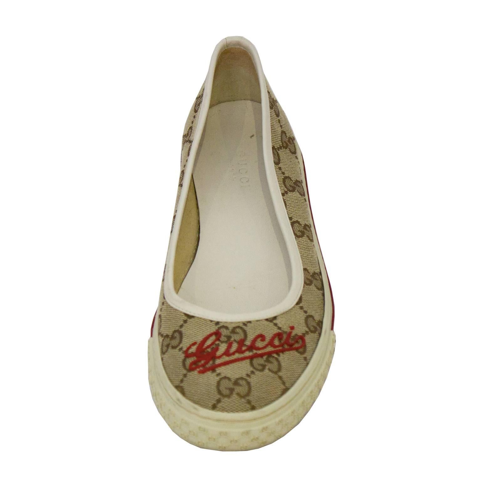Fashionable Gucci Monogram Flats feature signature brown GG monogrammed canvas, and has red cursive Gucci logo on each toe. White rubber sneaker style sole, embossed with gucci monogram print around toe. Super chic and easy to wear. Excellent