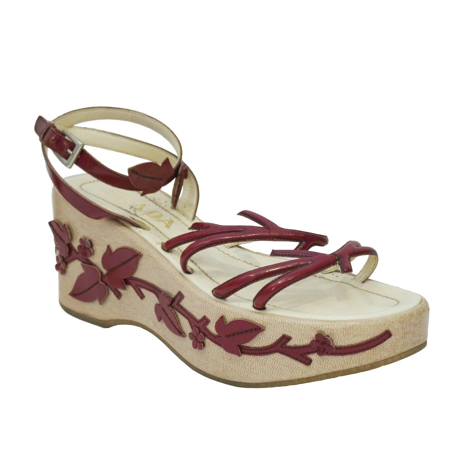 Fabulous platform wedge sandals from Prada's spring/summer 1997 collection. Platform is a nude color, decorated with stunning leaf and vine design crafted from wine red leather. Delicate ankle straps paired with chunky platforms are a staple of 90's