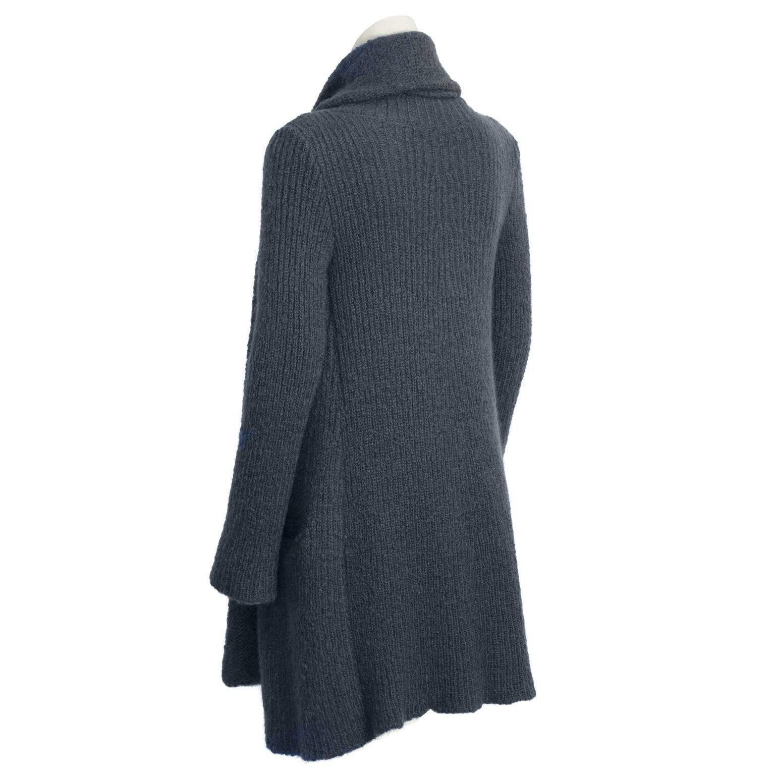 This cozy Sonia Rykiel slate hand knit cardigan with attached scarf is perfect to throw on over any outfit to stay warm. Open front, tunic length, slight A line silhouette cardigan has two slit pockets at the hips. Scarf can be worn with the