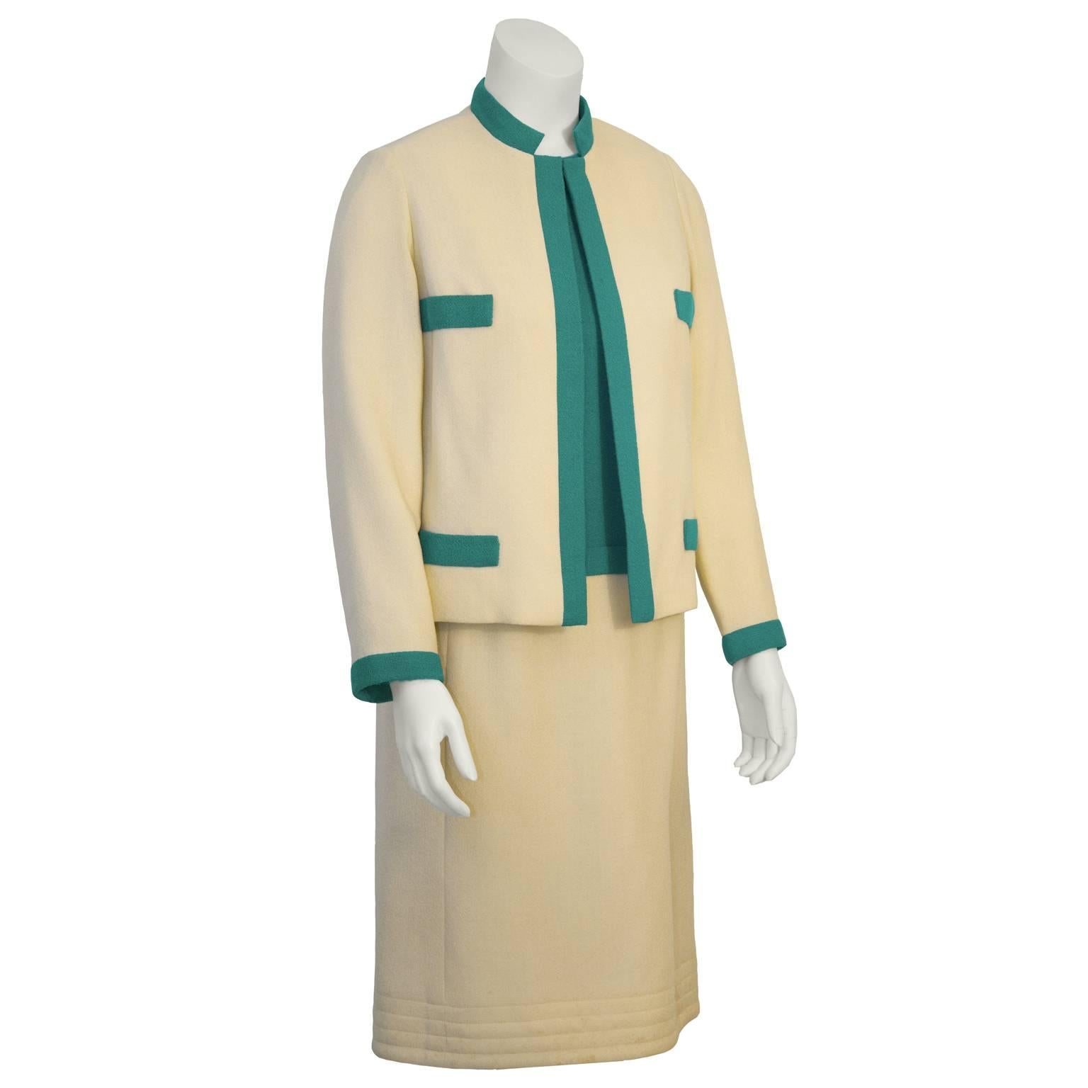 Chic 1960's Mary Korolnek cream and green raw silk dress and jacket ensemble. Jacket has green trim, four faux green flap pockets, and a single hook and bar closure. Classic Chanel inspired ladylike ensemble.  Sleeveless sheath dress has a green