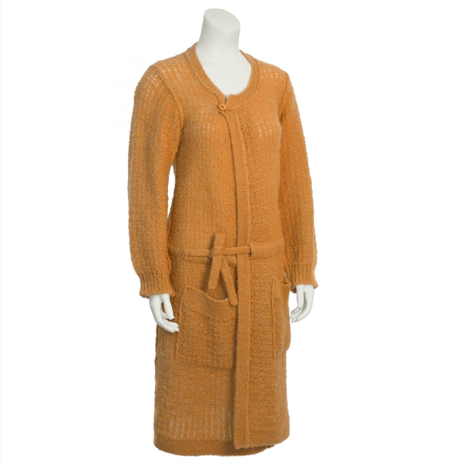 Cozy peach wool hand knit  Sonia Rykiel car coat style cardigan from the 1980's. Features a single button closure at the neck, and drawstring at the hip. Two over sized patch pockets at the hip. Excellent vintage condition. Flexible fit from US 4-8.