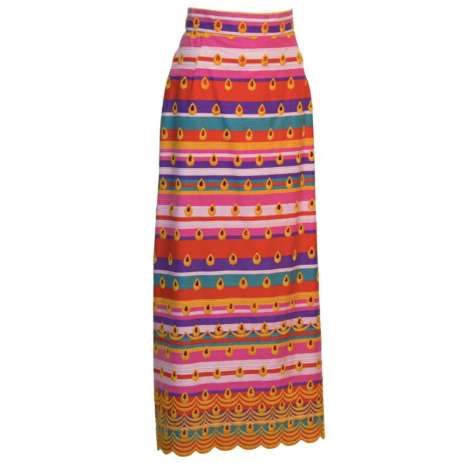 This is a unique and decorative Morton Myles for Malcolm Charles multi color BOHO maxi skirt from the 1970's. Made with a vibrant striped fabric in red, pink, magenta, purple, orange and turquoise. Detailed with yellow hand embroidery in a teardrop