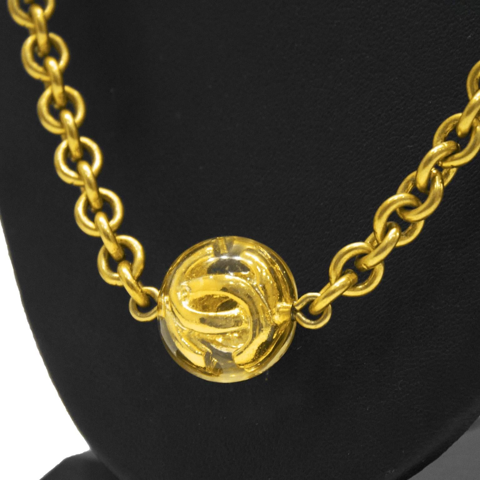 Dazzle with this fabulous Chanel gold plate chain necklace from the year 1990. Features transparent plexi-resin spheres along the chain, all with the floating Chanel CC logo inside. Spring ring clasp closure. Excellent vintage condition. 

Sphere