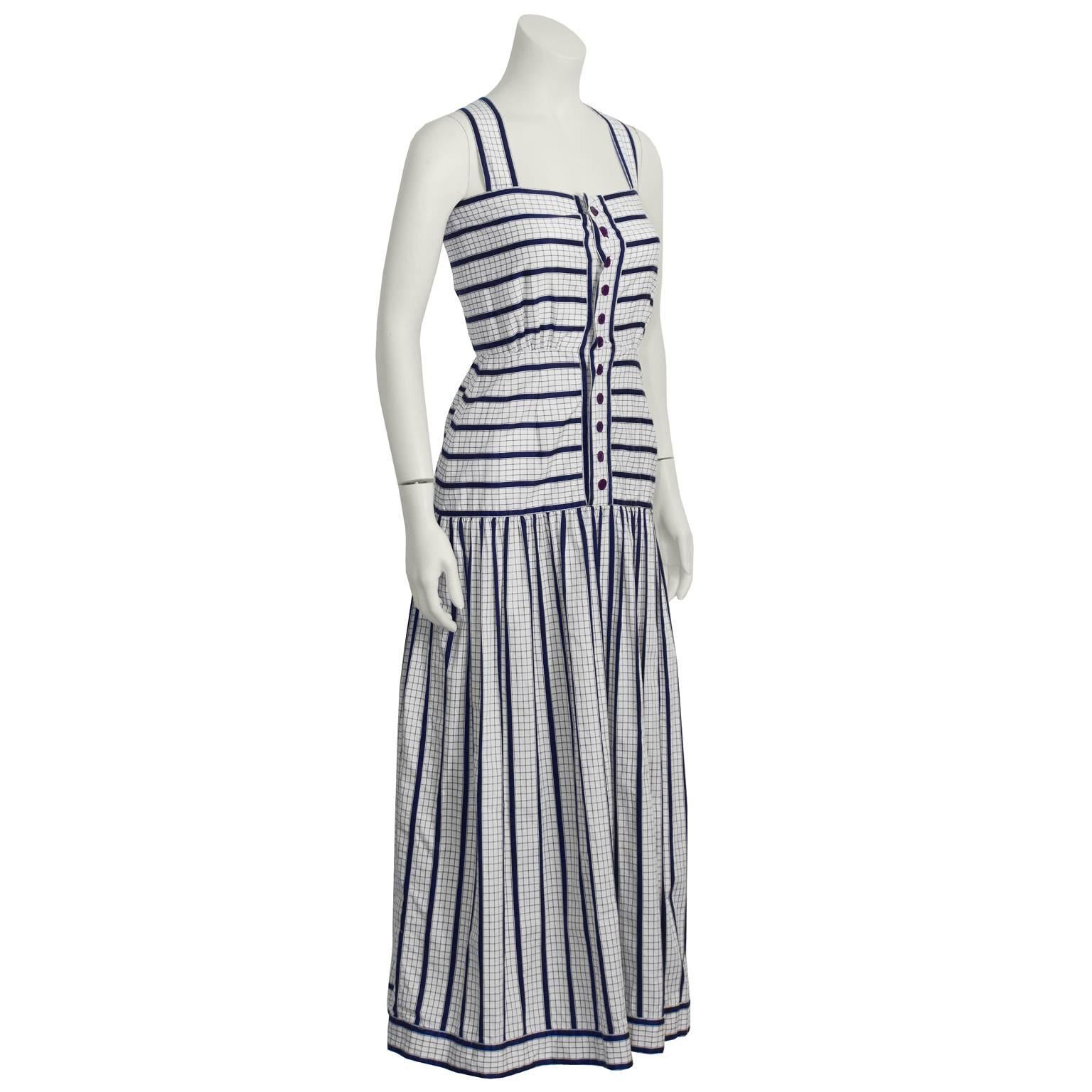This 1970's Adele Simpson cotton maxi sundress is checkered white with navy stripes. Features a fitted waist, front button closure, and gathering at the hip set skirt. Excellent vintage condition. A wonderfully feminine and sweet summer item!  Fits