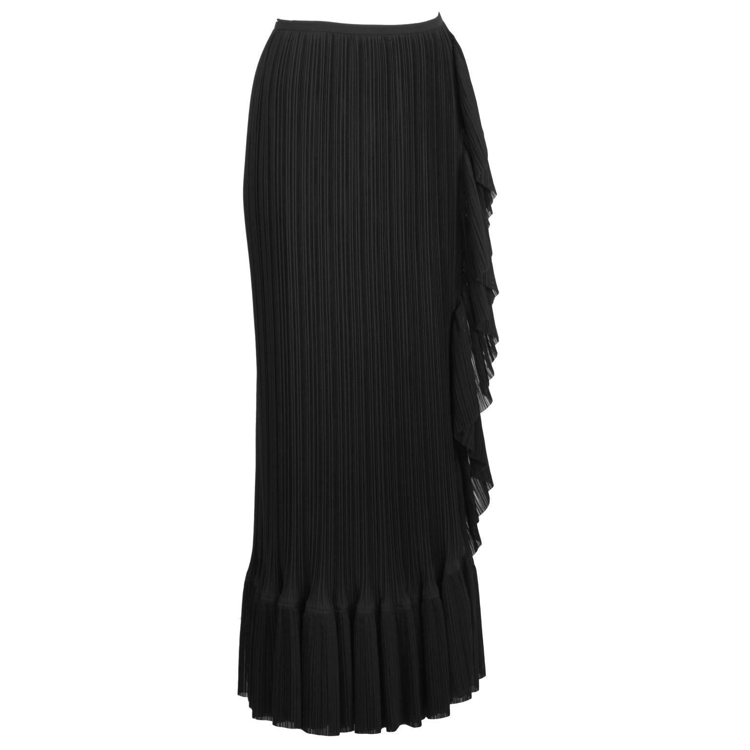 Lovely Issey Miyake pleated black skirt from the 2000s. Wrap style mid-length skirt featuring a frill hem and side zip closure. Excellent vintage condition. Fits like a US 6. 