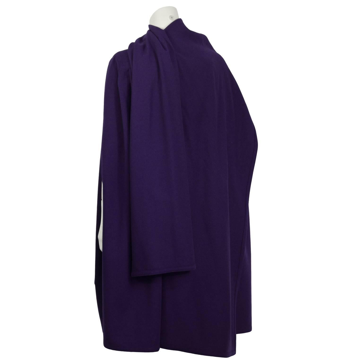 Add some color into your winter wardrobe with this elegant Scherrer cape with an attached shawl from the 1980s. Constructed with softly pleated purple wool and features two oversized patch pockets, and a single button at the yoke. Excellent vintage