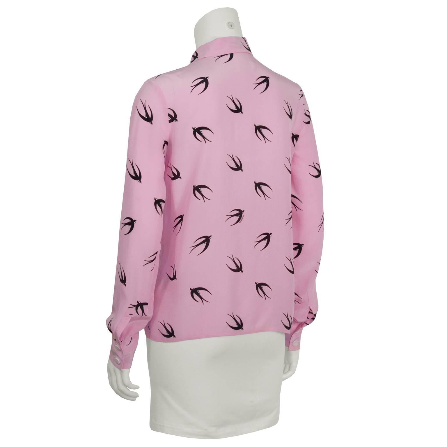 Adorable Miu Miu pink silk blouse with a black swallow print from the spring 2010 collection. Features a classic collar and front button closure. Two buttons at each cuff. Excellent condition. Fits like a US 2.