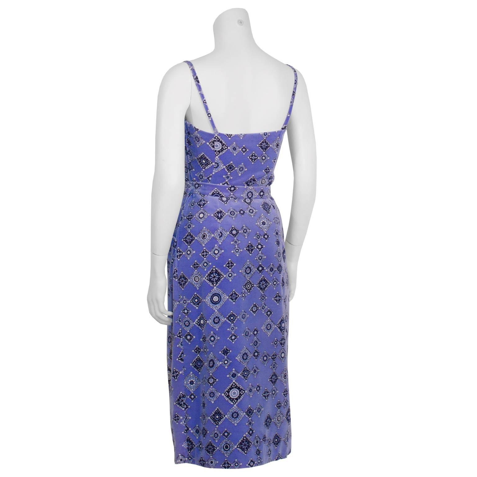 Amazing 1970's Emilio Pucci periwinkle velvet ensemble featuring a corset style top and straight cut skirt. Top has two small slits and a side zip closure. Skirt features fixed pleats and a side zip closure. The lovely pattern has notes of white,