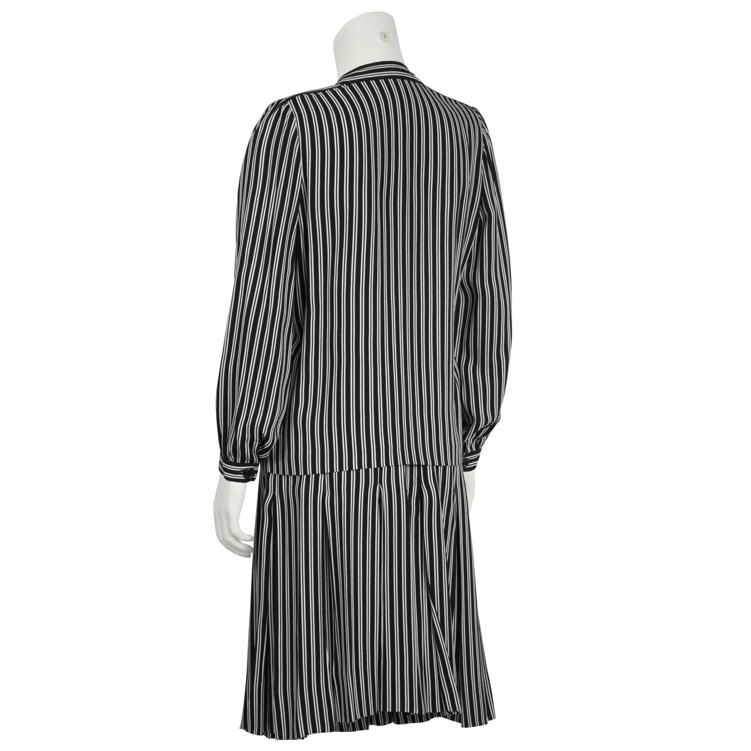 Chic Givenchy black and white striped set from the 1980's that can be worn separately or together. Top features a deep v-neck and a front button closure. Skirt is straight cut with a side zip closure. Excellent vintage condition. 

Top: Length 25