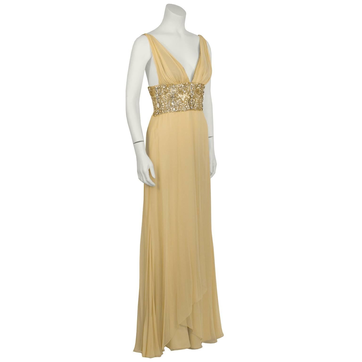 Elegant American couture designer Randhi Rahm  gown from 2009. Butter cream chiffon dress features v-neck with a gathered chiffon layer over bra shape cups, and a gorgeous bodice encrusted with gold and silver sequins and beads. Side zip closure.
