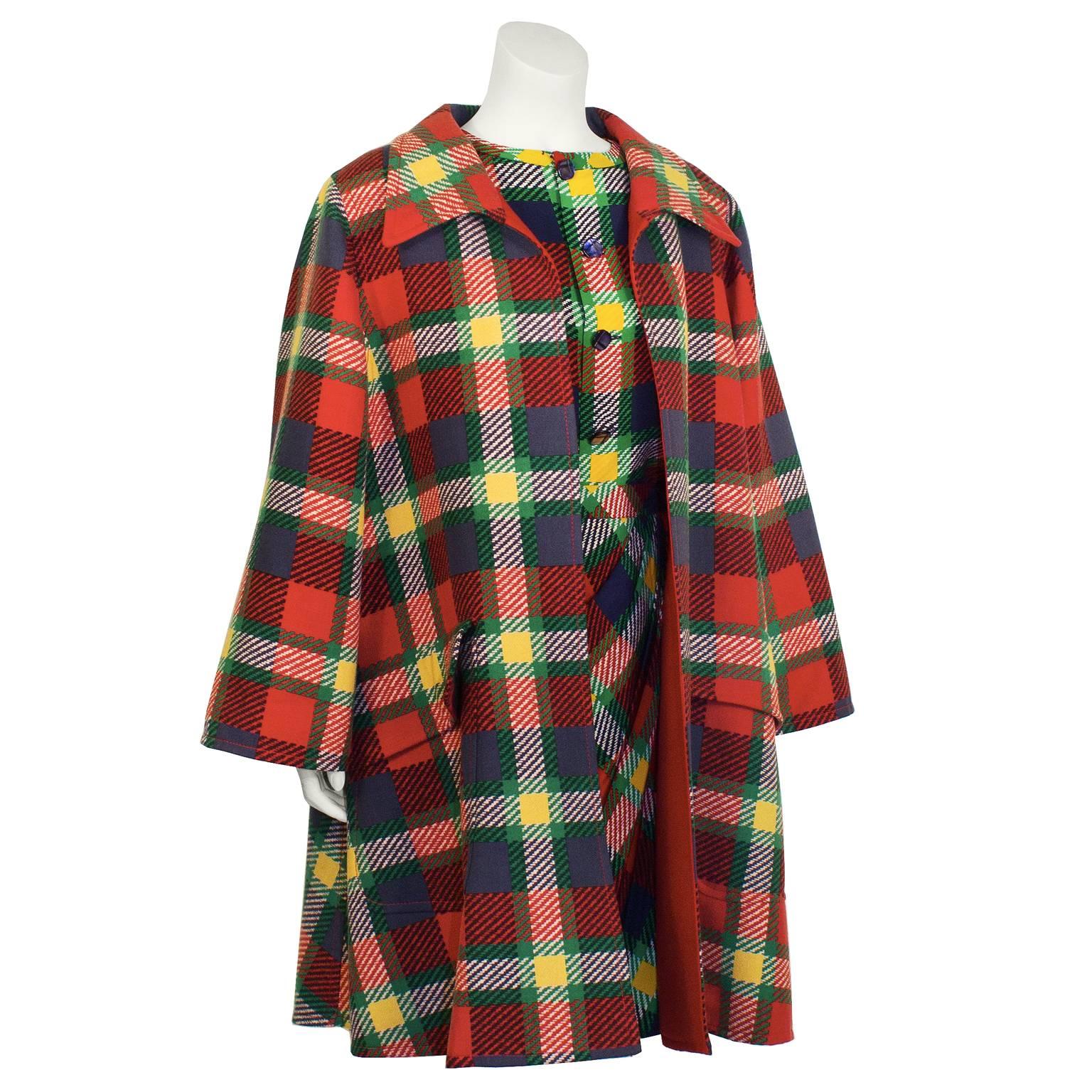 Chic 1980's Valentino vibrant plaid ensemble including a silk blouse, skirt, and adorable A-line coat. Long sleeve blouse has a front button and frilled cuffs. Skirt is a faux wrap with a side zip closure. A-line coat features a wide collar, and two