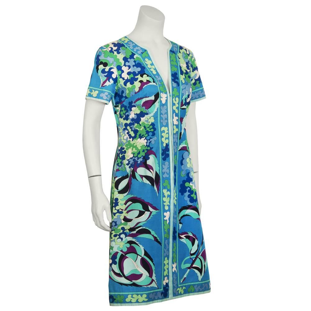 Cotton Pucci day dress from the 1970's. Blue, green and purple clover and leaf print cover the front and back of this dress with a printed stripe down the front and along the V neckline, hem and sleeves. Zipper up the front, in excellent condition.