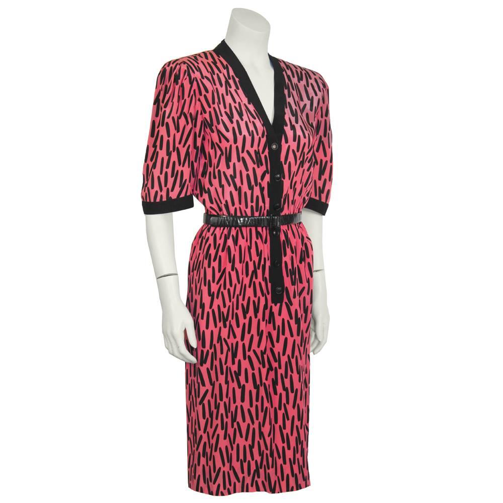 1980's Scherrer fuschia and black paintbrush pattern silk dress. V neck and mid-length sleeves are trimmed in black, and fastens at the front with black buttons. Elasticized waistband creates a flattering shape that counters the slightly padded