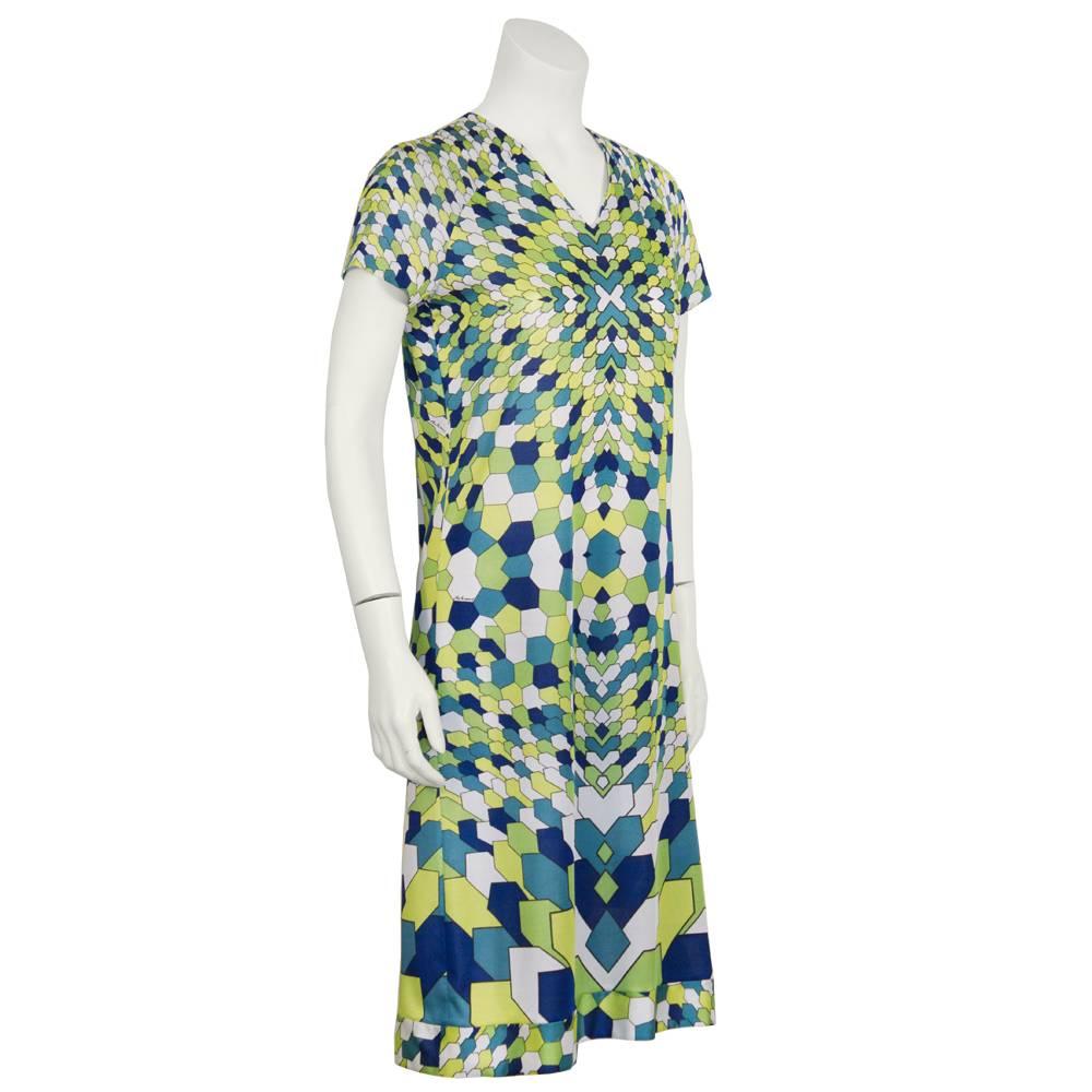 Like new 1970's Artemis polyester t-shirt dress with an all over Pucci inspired geometric print in lime green, white, teal, and navy blue. Constructed with short sleeves, a v neck and a back zip closure. Excellent condition. Fits like a US 4. Unique