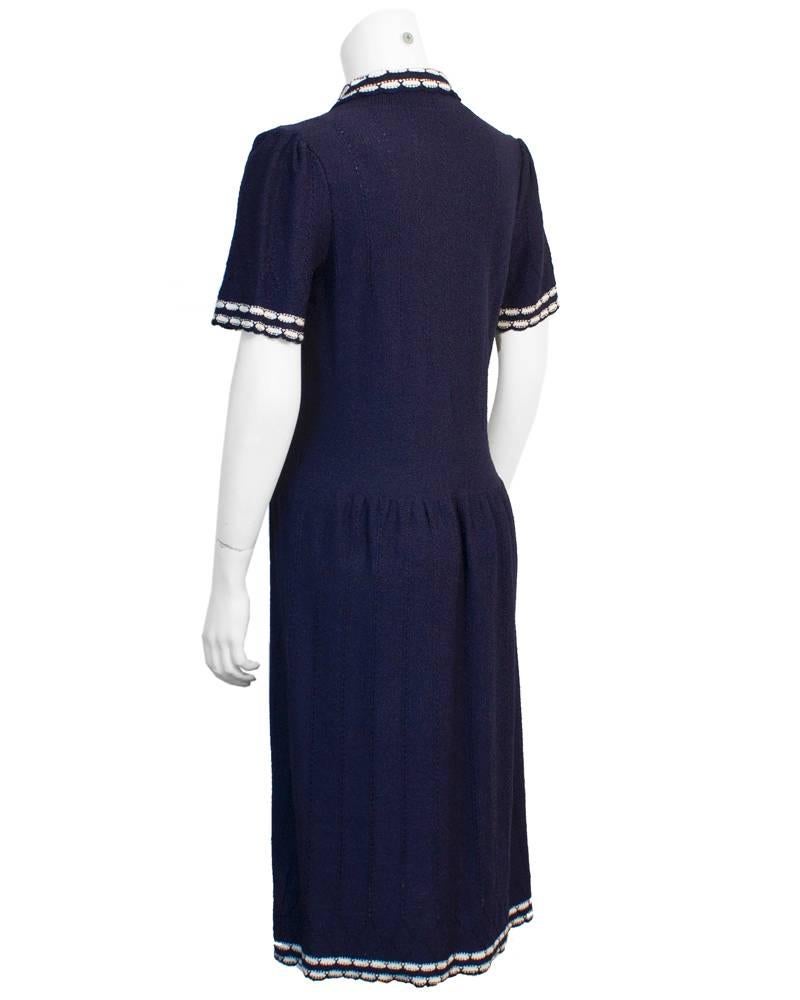 Beautifully knit Adolfo day dress from the early 1980's. The entire dress is knit in a rich navy cotton blend and the classic dress shape holds perfectly with the smooth bodice transitioning into a gathered waistline and skirt. The sleeves, hem and