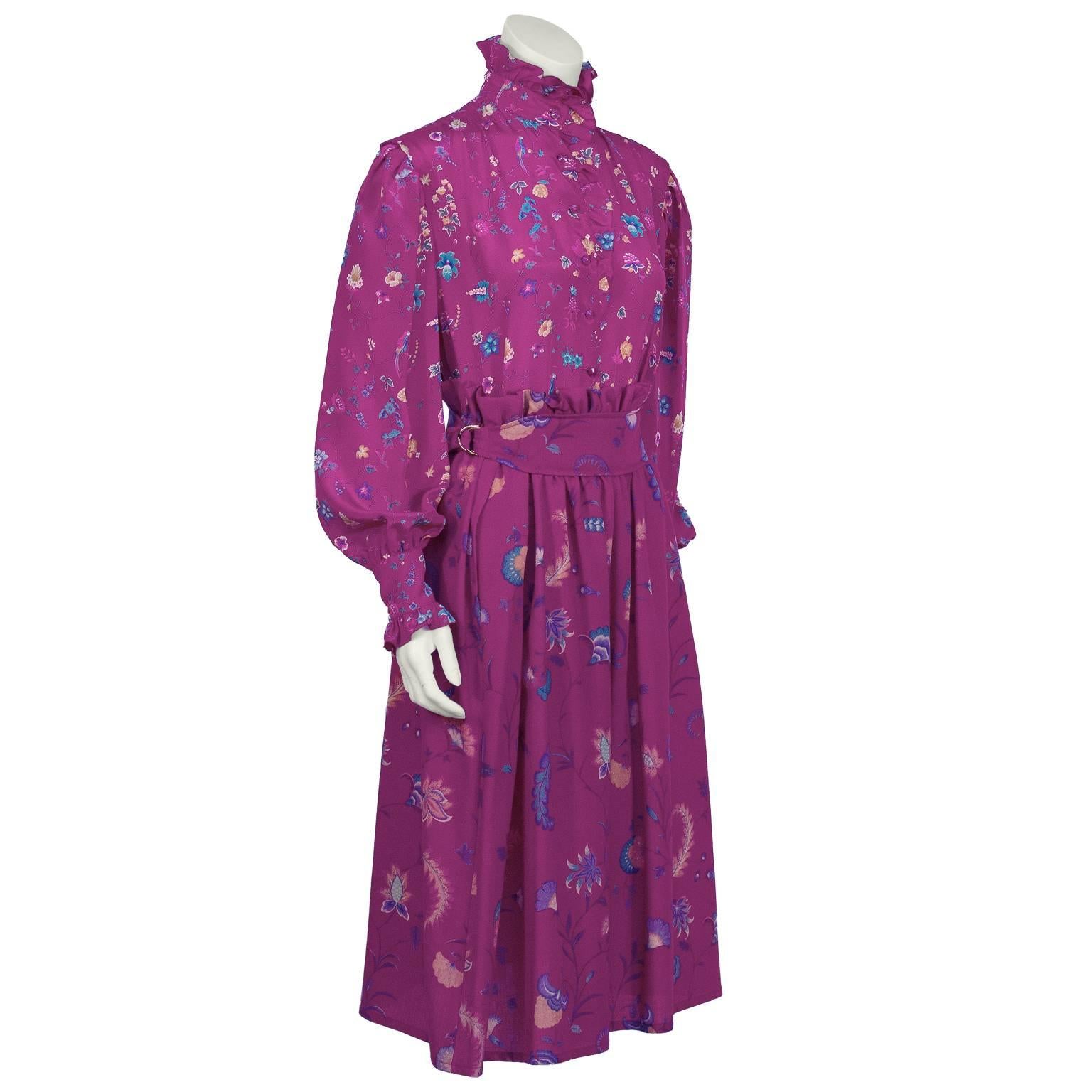 Brilliant Ungaro magenta floral outfit from the early 1980’s. The wool challis skirt and silk shirt feature the same overall pattern of teal, gold and pink flowers with parrots. The skirt is gathered dirndl style with inseam pockets and falls to the