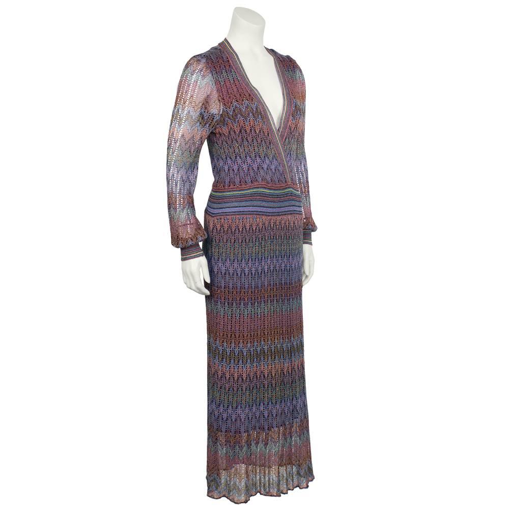 1970’s classic Missoni crochet technique knit sweater dress in purple, teal, yellow and mauve. The deep V-neck dress has a cross front that finishes at a stretchy waist band giving the dress some shape. Midi length to the mid calf or ankles and the