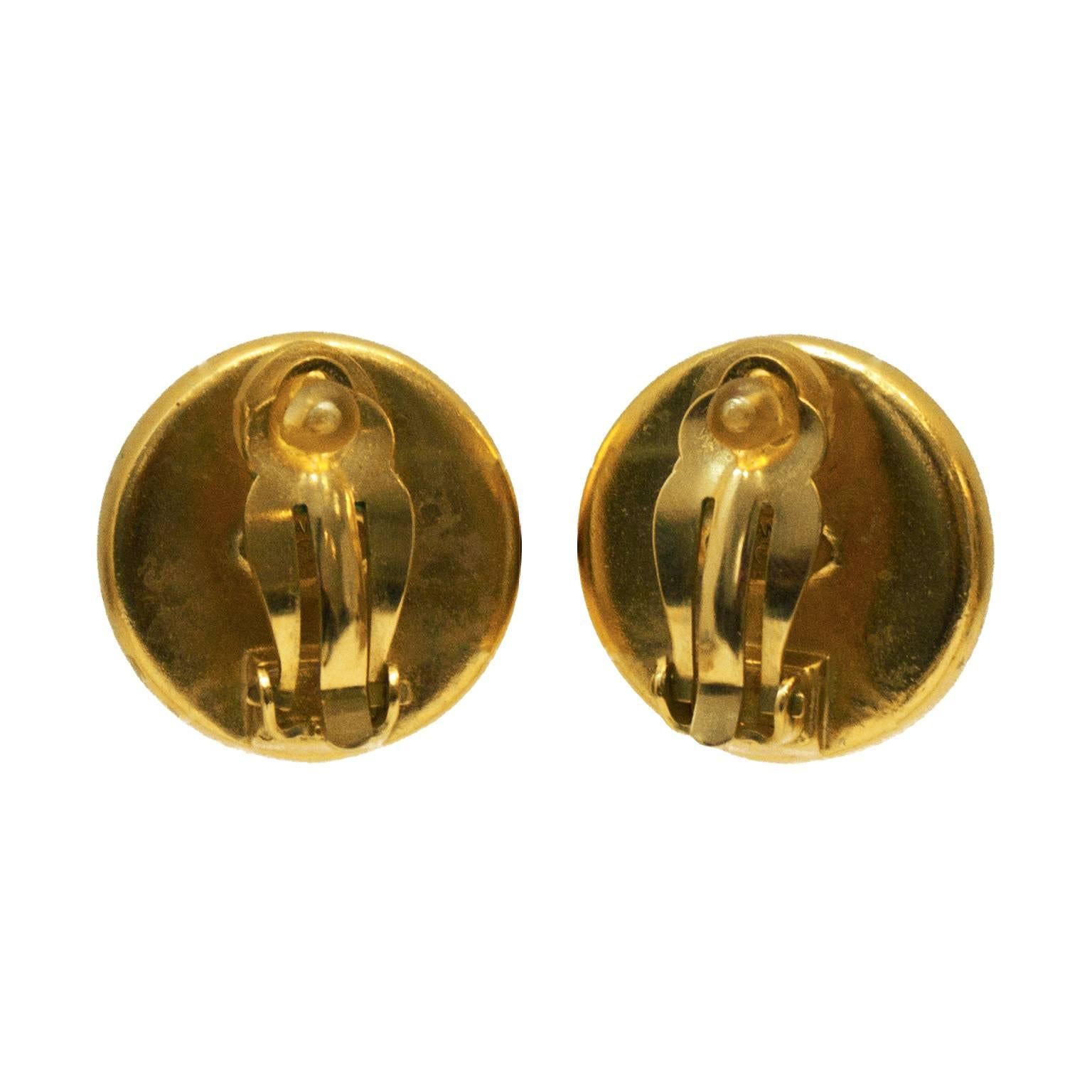 Chanel gold plate and poured glass CC clip on earrings from the Spring 1999 collection. Poured glass is imprinted with a CC and Chanel Paris around the border. Excellent condition. 