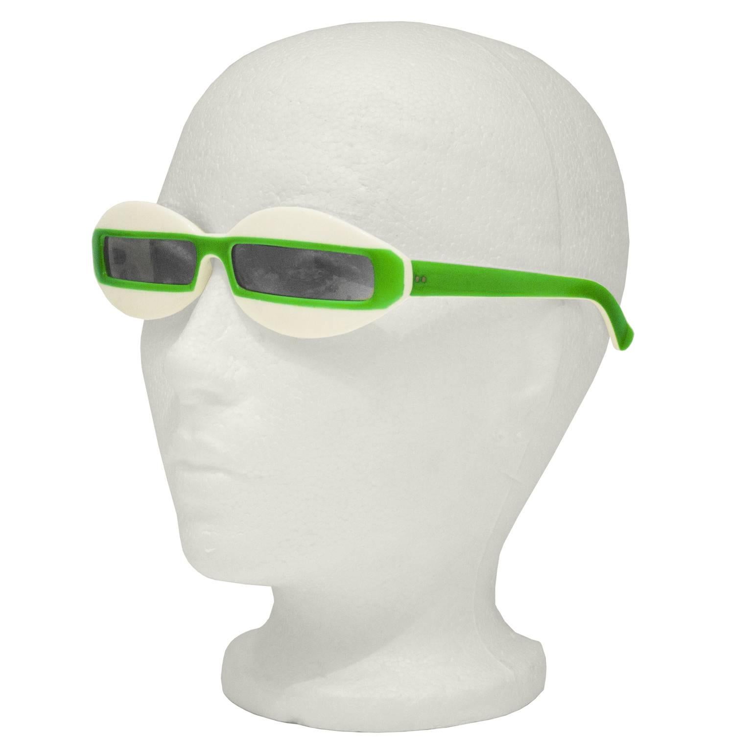 Great looking Italian made Courreges inspired sunglasses from the 1960's. Futuristic style features narrow rectangular lenses on a cream background with a lime green stripe that continues down the arms. In excellent condition. Not prescription.