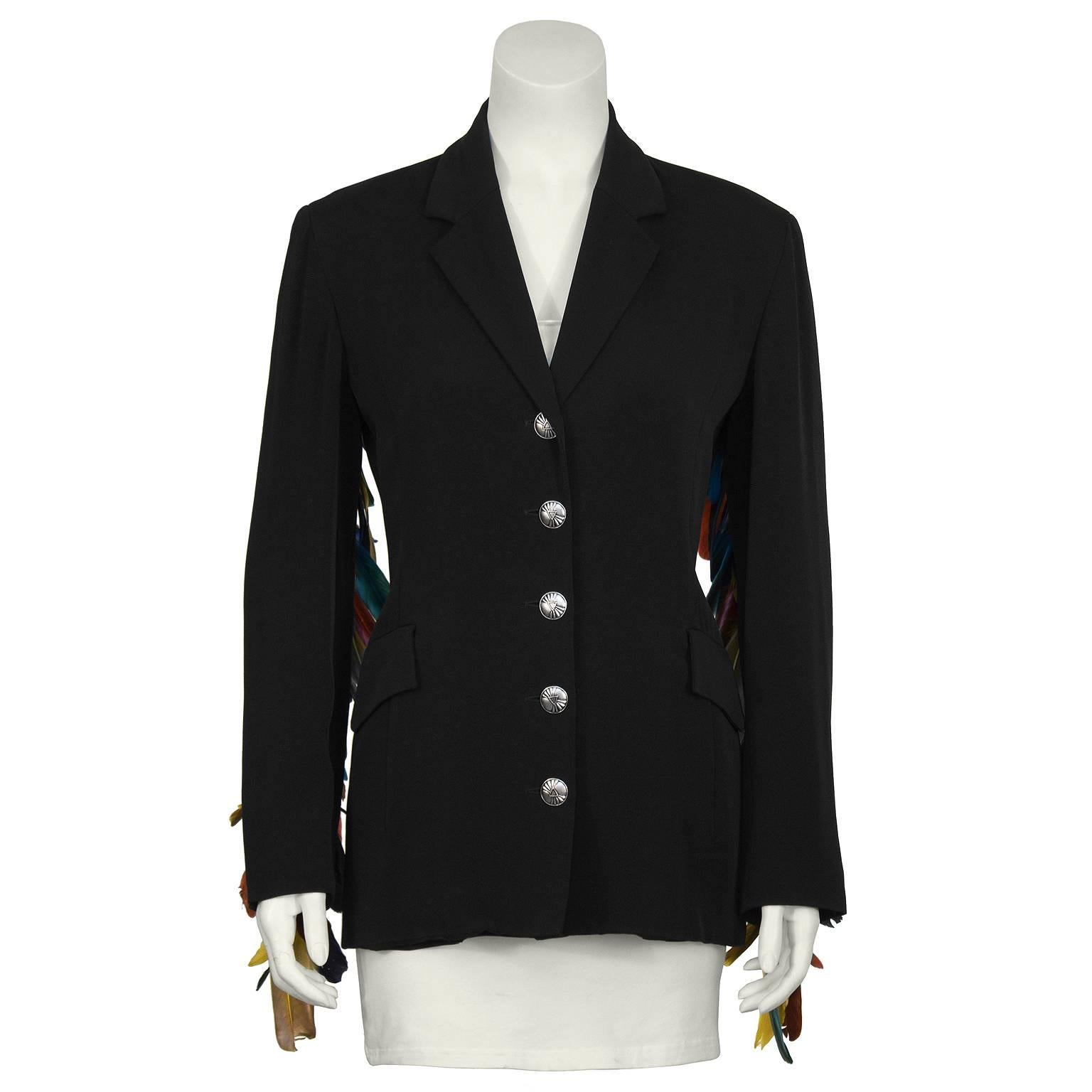 Incredible black gabardine Ozbek blazer from the 1980's. Tailor fitted jacket features notched lapels and 2 flap front pockets. Unique and exquisite row of metal ball beads and vibrant colorful feathers adorn the length of each sleeve. Fully lined