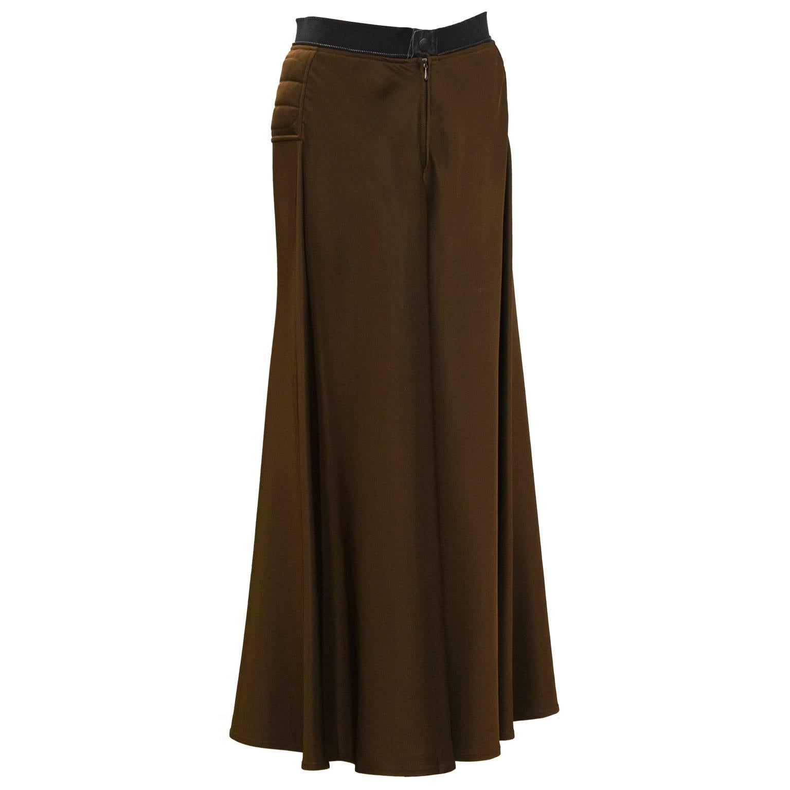 Early 2000's Gaultier brown maxi skirt.  Horizontal quilting details on the hips with a pant style front button and zipper closure. The cotton waistband is fashioned from a standard zipper showing the metal edge. In excellent condition. Fits like a