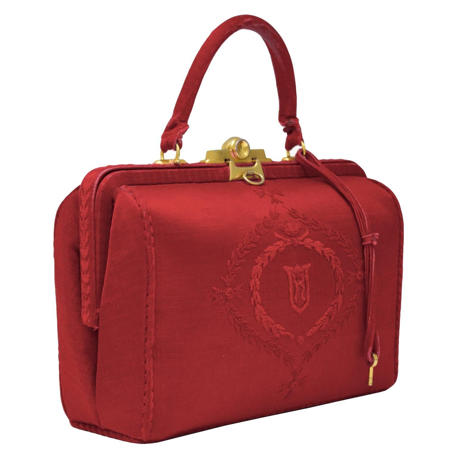 1960’s Roberta di Camerino red cut velvet doctor style bag with an R logo crest on both sides. Gold hardware and slide top clasp. Lined in red leather with two small pockets and one zipper pocket.  Slight wear to top handle and includes a key to