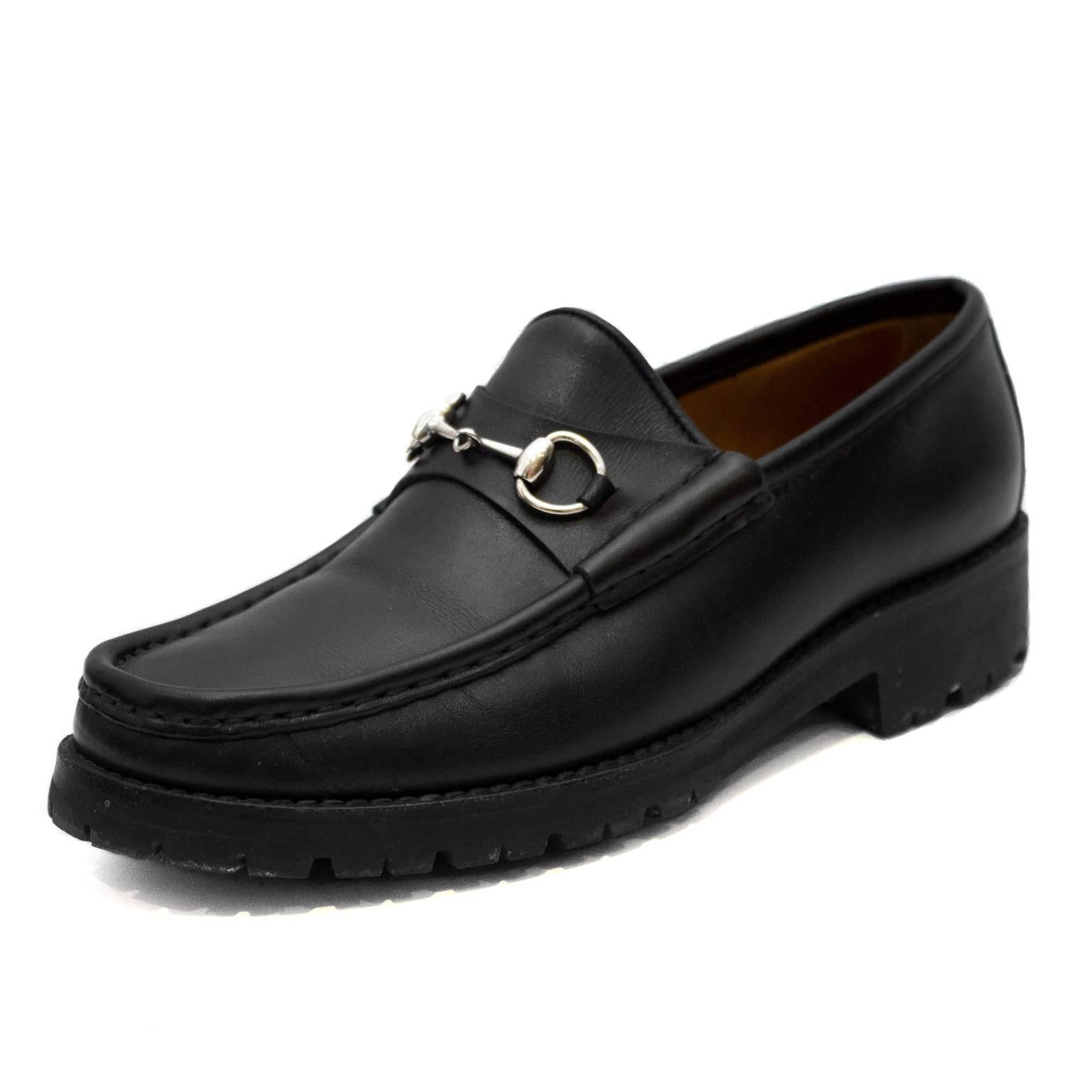 1990's Gucci black lug soled loafers with silver horse bit detail. Flat matte black leather. Interior is tan leather. Size 7b. Excellent condition. Classic and timeless.
