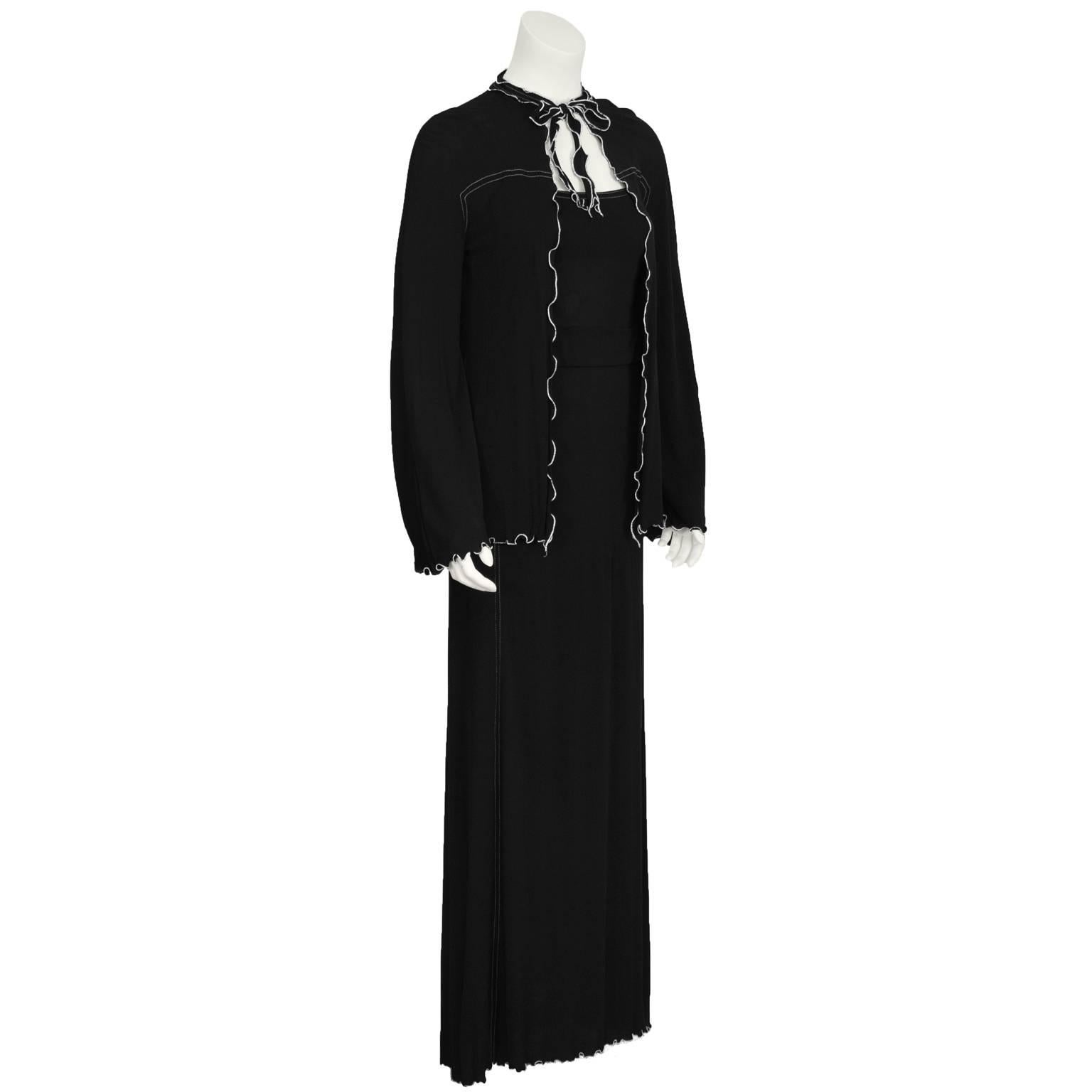 1970's Anna Beltrao black rayon jersey dress and jacket set with white lettuce edge trim. Ms. Beltrao was a contemporary of Ossie Clark, Janice Wainwright and Jean Muir.  Sexy black maxi dress has spaghetti straps, attached fabric belt and white