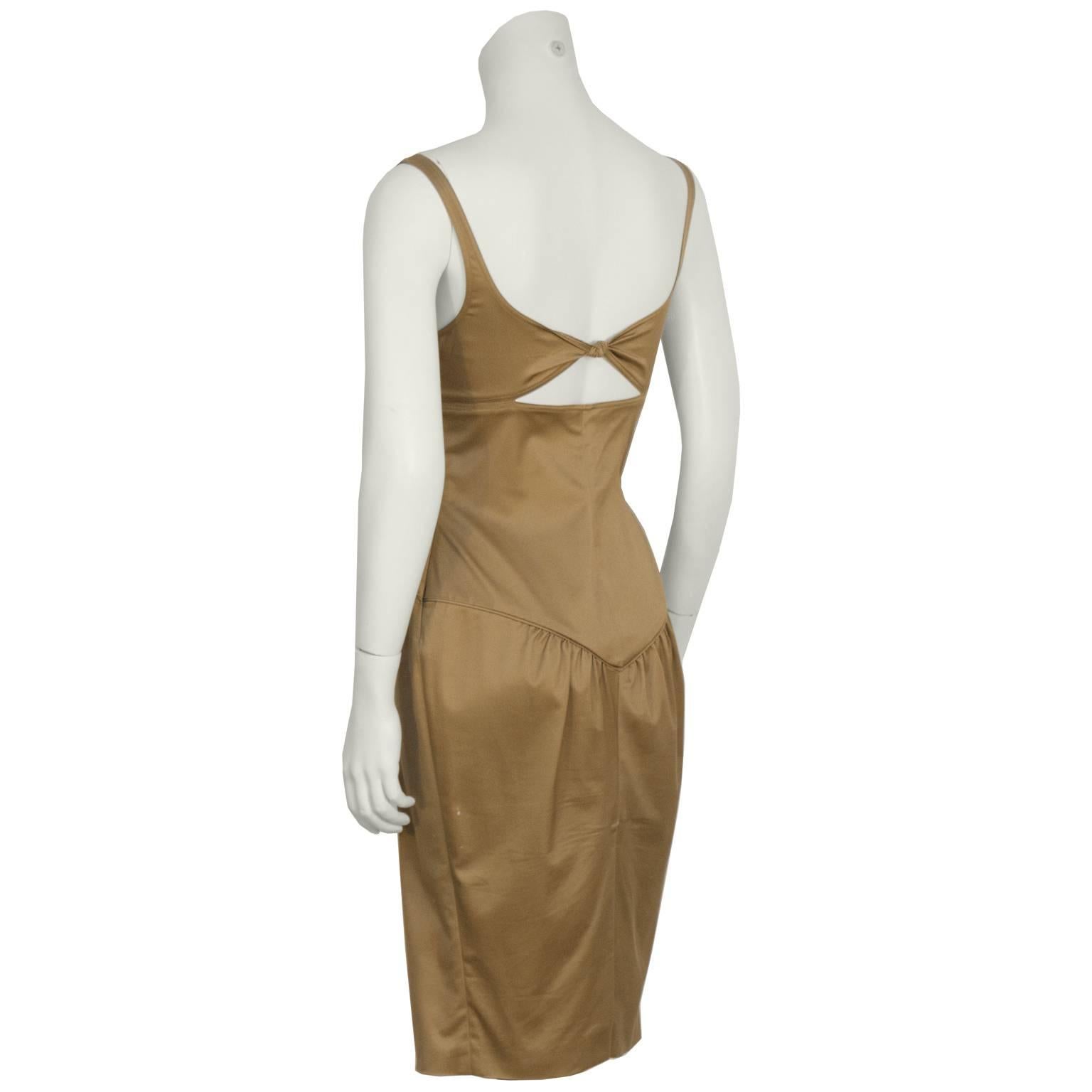 Gucci by Tom Ford khaki wiggle dress with matching jacket from the Fall/Winter 2003 collection. The fitted dress has a corset like bodice, with a scoop neckline and gathering at the bust. The back has a small cutout with a knot, and a slit at the