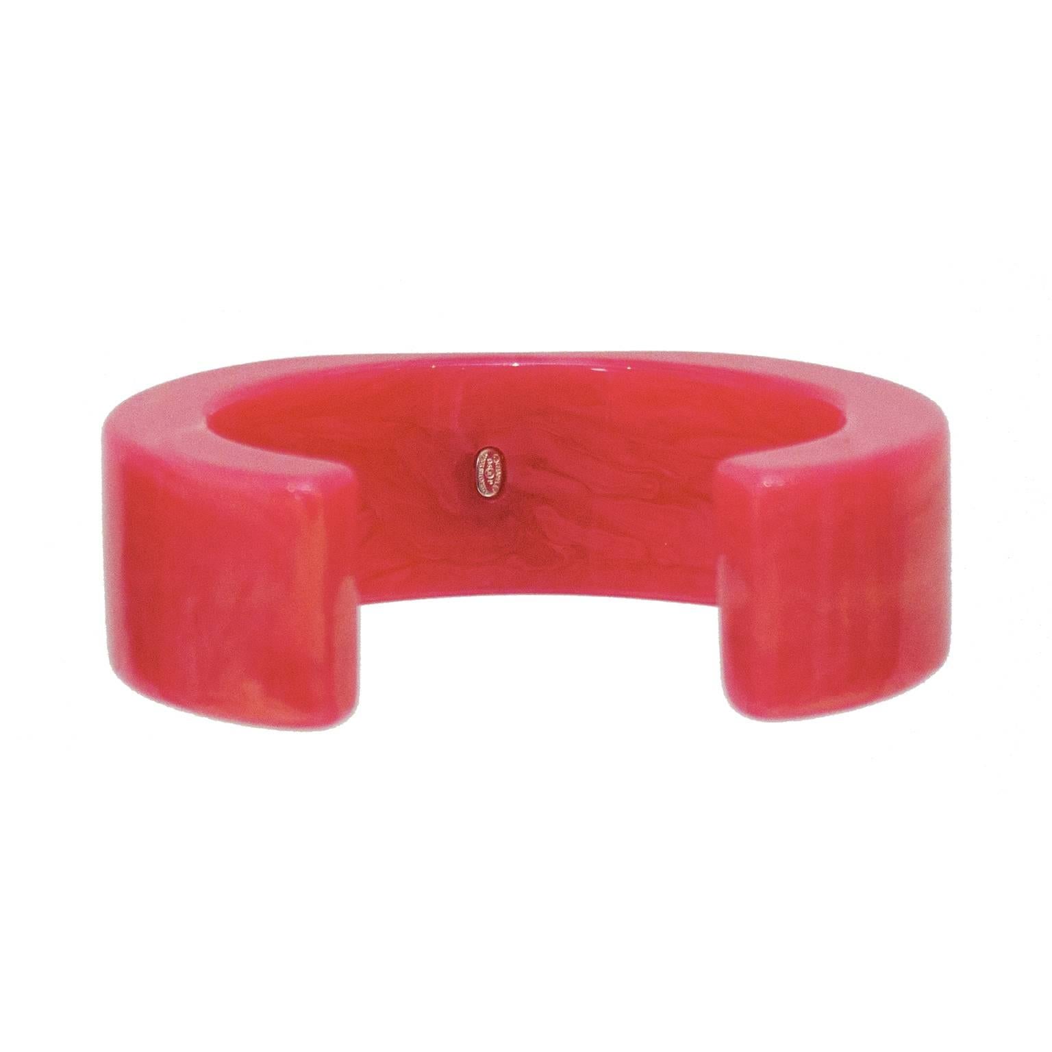 Spring 2004 Chanel pink marbleized resin cuff with jade tone CC at the center. Cuff has a squared edge and a faint gold shimmer.  In excellent condition. Signed on the underside. 
