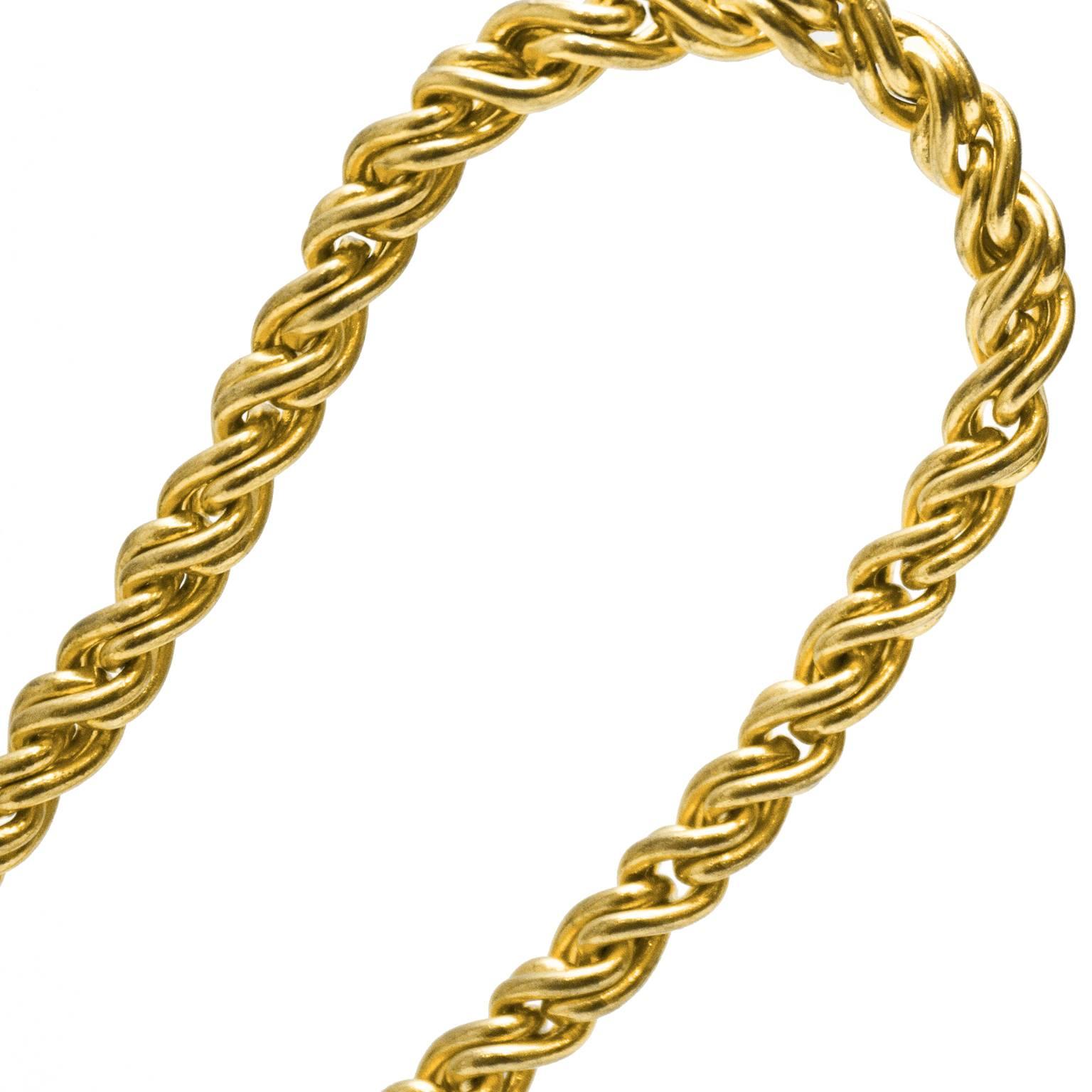 Yves Saint Laurent gold tone twisted rope style chain necklace from the late 70’s, early 1980’s. The necklace has a nice weight to it and closes with an S hook. A signed YSL tag hangs from a jump ring at the clasp. In excellent condition.
