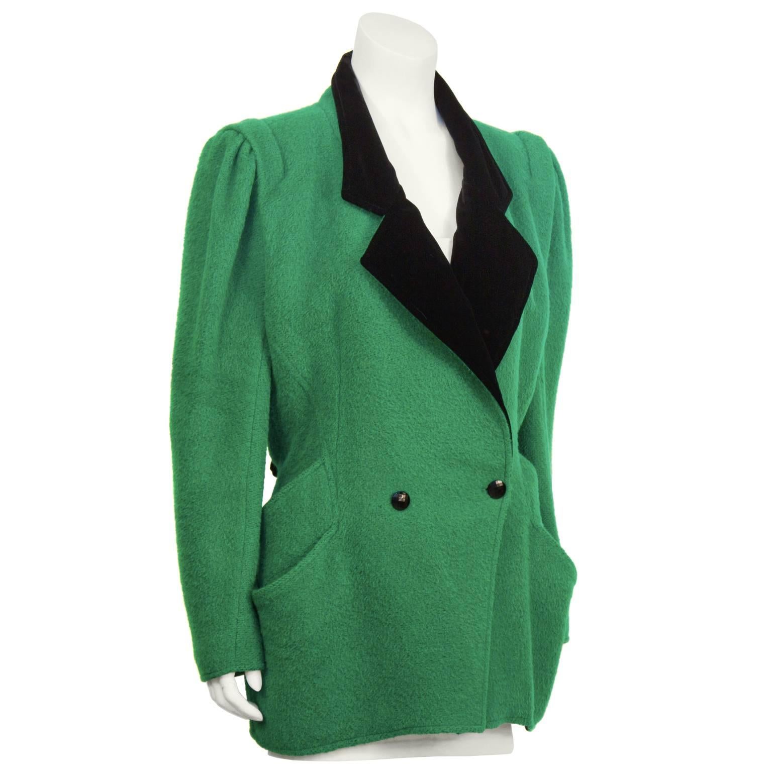 Ungaro 1980's kelly green boiled wool hacking jacket with black velvet collar. The double breasted jacket features an oversized shoulder, fitted waist, with double layered diagonal pockets. Shiny black faceted buttons on the front and at the cuffs