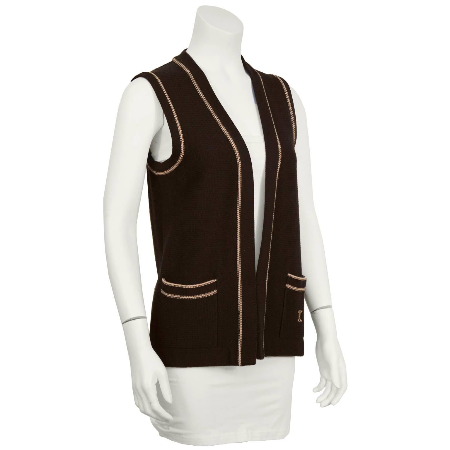 1970's Celine brown wool knit vest with two front pockets featuring knit peach piping detail and embroidered Celine logo on the left pocket. In excellent condition. Easily paired with T-shirt and jeans, this is a great accessory for any Celine