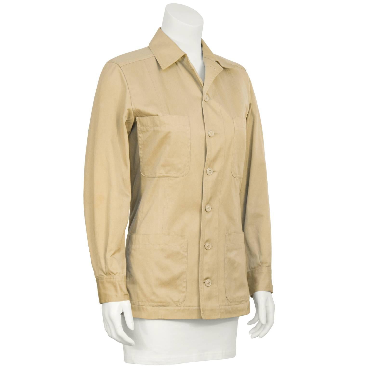 1990’s Yves Saint Laurent Rive Gauche safari style jacket in cotton khaki. The jacket buttons down the front and features four pockets at the breast and at the hips, finished with a buttoned barrel cuff. In excellent condition. Fits like a US 4.