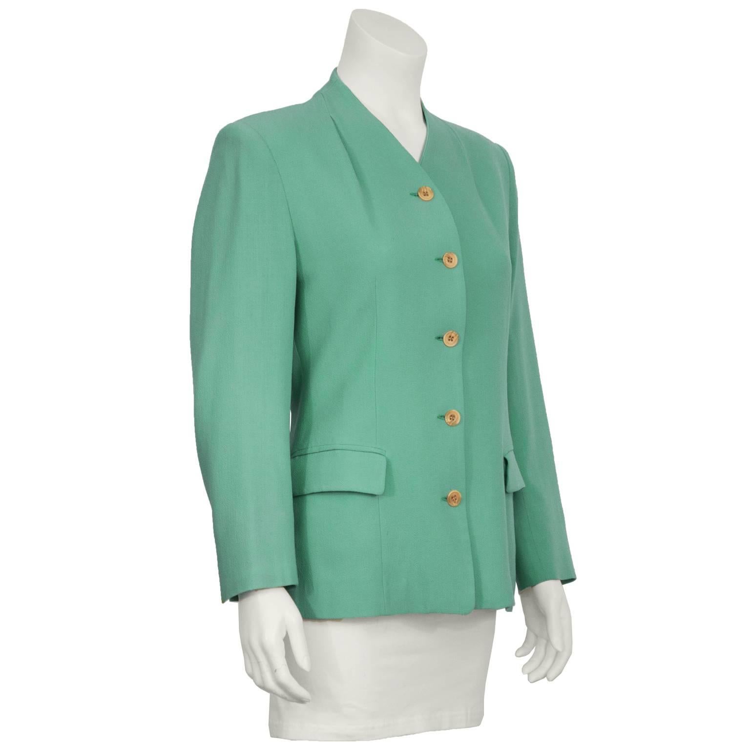 Jasper Conran mint wool crepe collarless jacket from the 1980's. The jacket features a dart at the top of the neckline by the shoulders, two front flap pockets and a split cuff. Marbleized beige plastic buttons down the front. In excellent