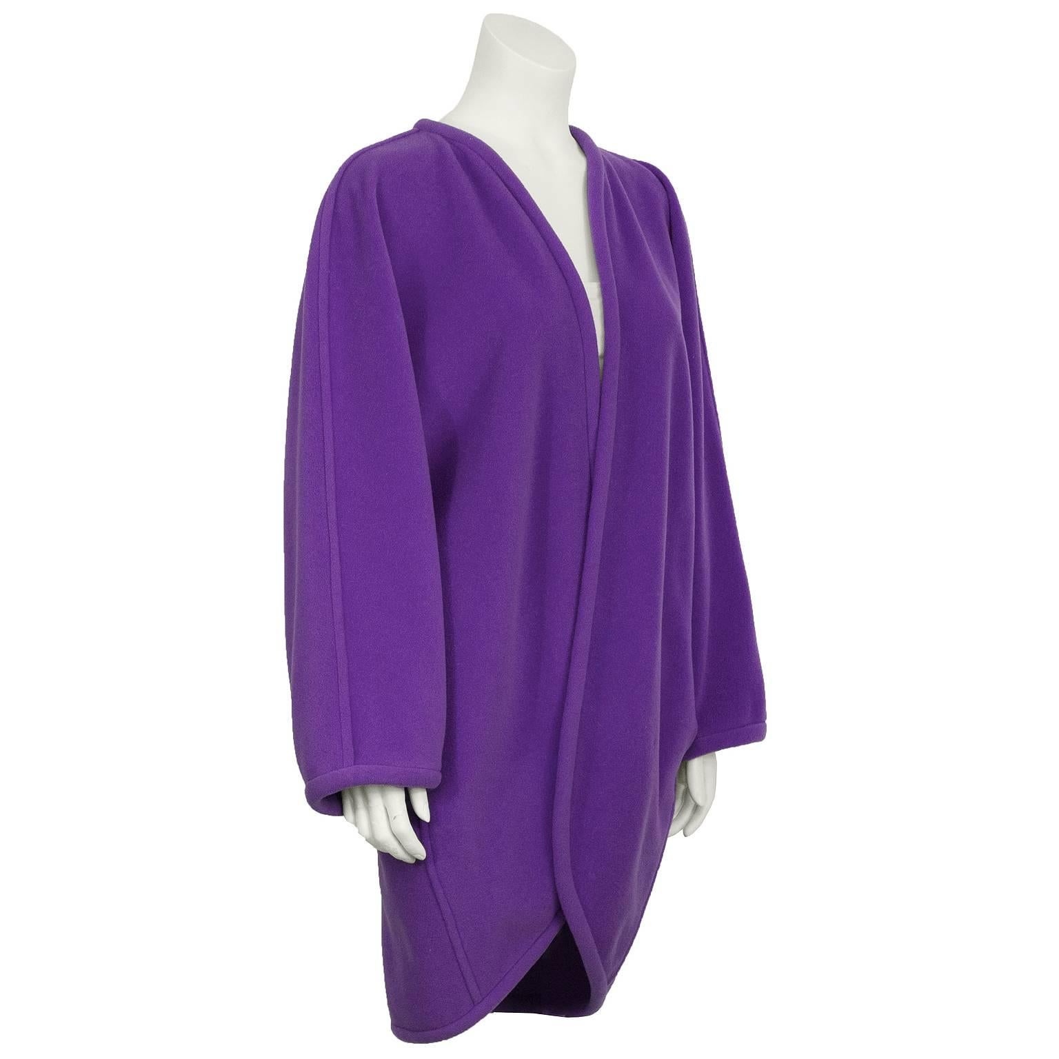 Ungaro felted wool purple oversized cocoon jacket from the 1980’s. The jacket featured a rolled detail along the trimmed edge and the cuffs. Similar detail on the seams from the shoulder down to the cuffs and down the back. Two slit pockets on the