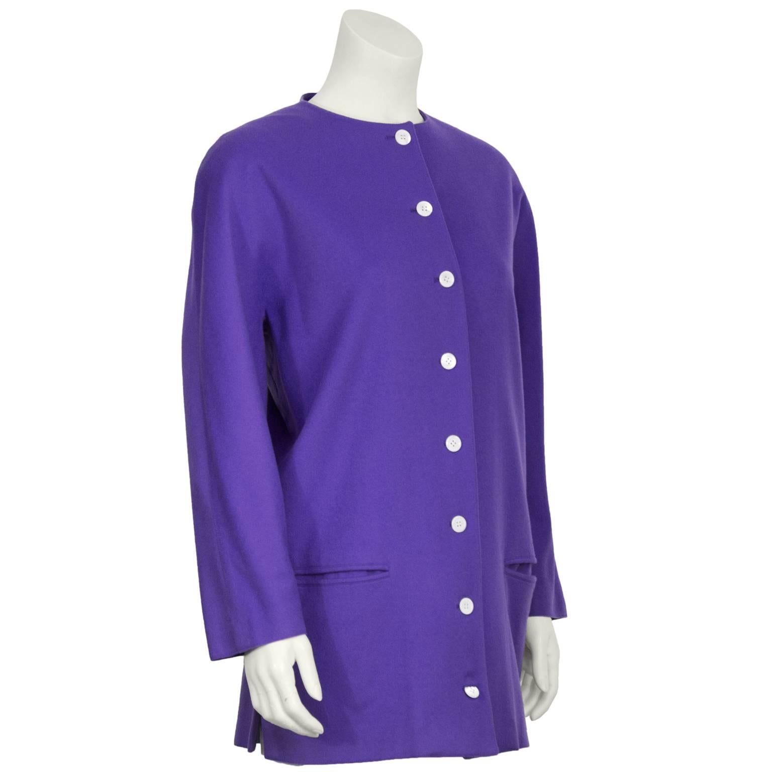 Genny purple wool button front jacket with front slit pockets. The collarless jacket features rounded shoulder pads and pearlized round buttons down the front. Fully lined. In excellent condition. Fits like a US 6.