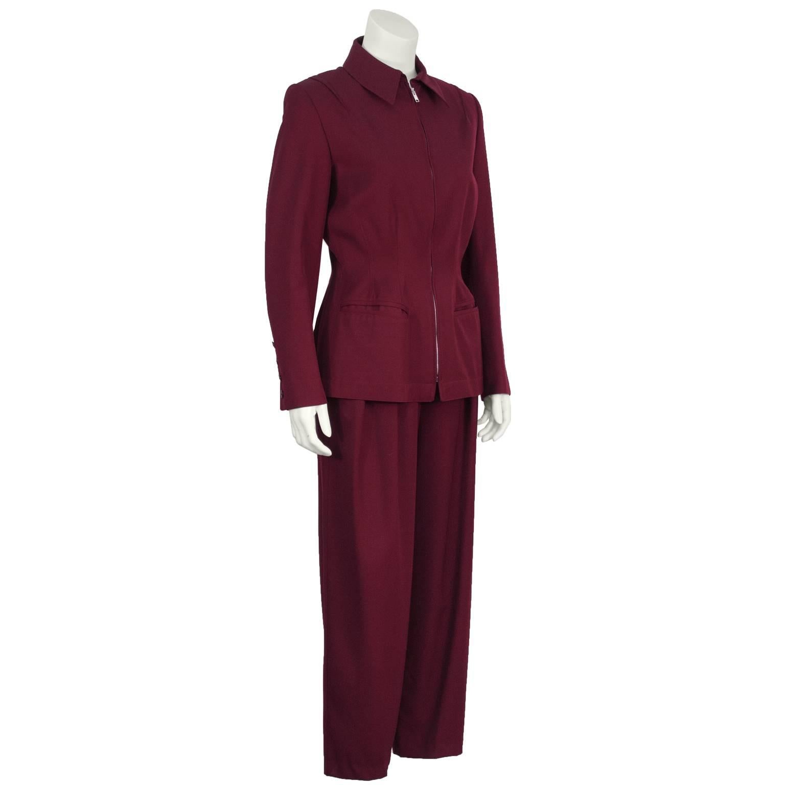 Claude Montana eggplant gabardine jacket and pant set from the 1980s. The collared jacket has a nipped in waist, two sleek slit entry pockets at the hips, and industrial zipper up the front. Shoulders are padded and sleeves are finished with four