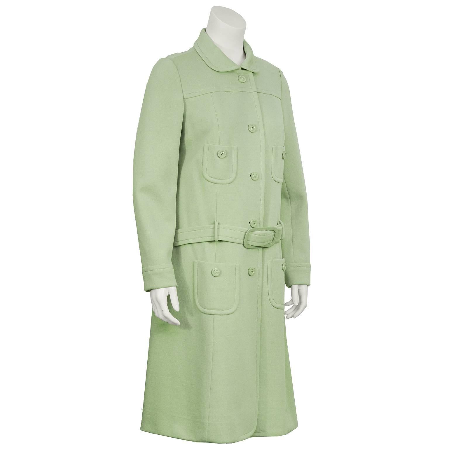 Mint green knit jersey Courreges style coat/dress from the 1960's. The coat features a rounded collar, four patch pockets with a button, and finished with a detached belt around the hips. Fastens down the front with green buttons. Excellent