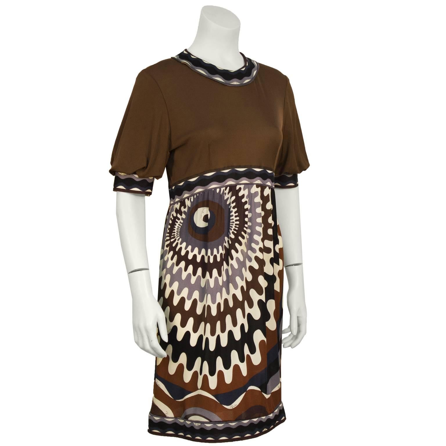 Emilio Pucci brown grey and white printed silk jersey mini dress from the 1960’s. The dress features a solid bodice with Pucci print banding at the neckline and at the empire waist, as well as the trim on the puff sleeves. The skirt falls to above