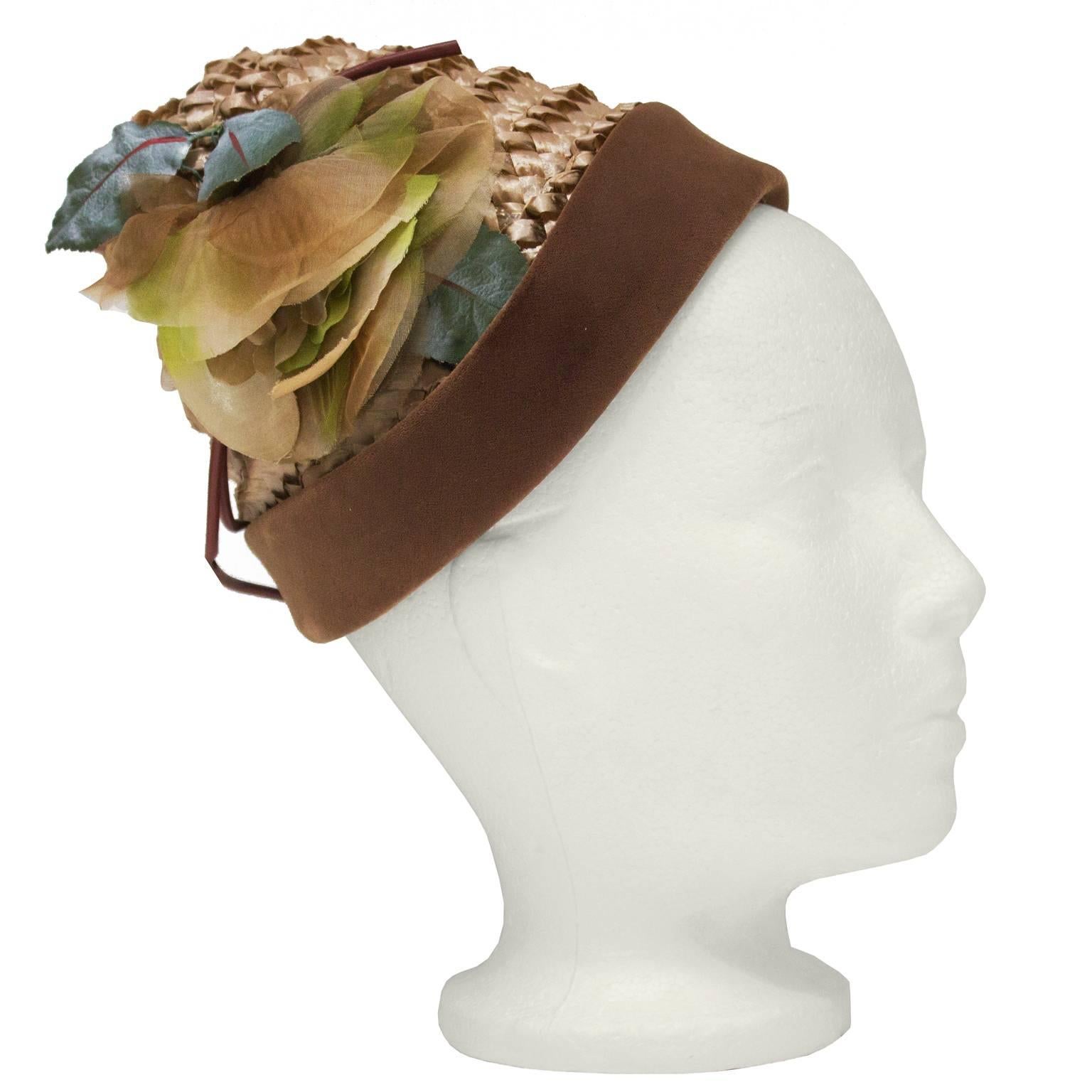 Henry Morgan whimsical beehive style hat straw from the 1950's. The woven iridescent hat is decorated with a faux flower on the side, and finished with a band of matching brown velvet. In excellent condition. Small fit. Meant to perch at a 