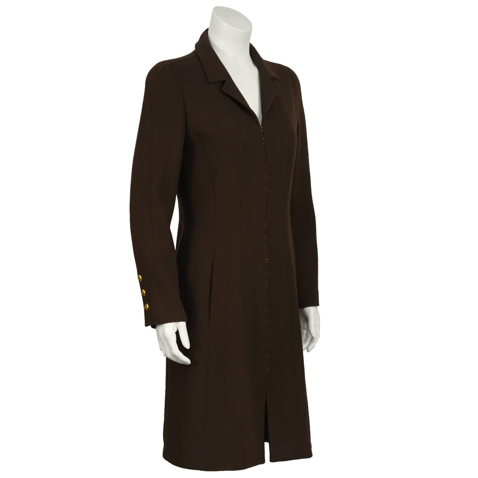 Chanel Fall 1996 brown wool crepe coat dress featuring a multiple gold hook  detail at the front. The coat features a petite notched collar and seams down the front with inseam pockets. The cuffs have gold cc buttons. In excellent condition. Fits