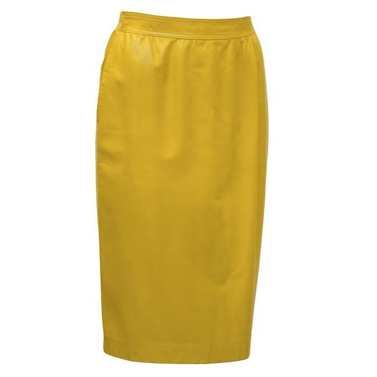 Emanuel Ungaro mustard yellow leather pencil skirt from the 1980’s. The buttery soft skirt has a banded waist with slight gathering in the front and two side slit pockets. Zips up the back, fits like a 2-4. Lined in matching tone silk. Excellent