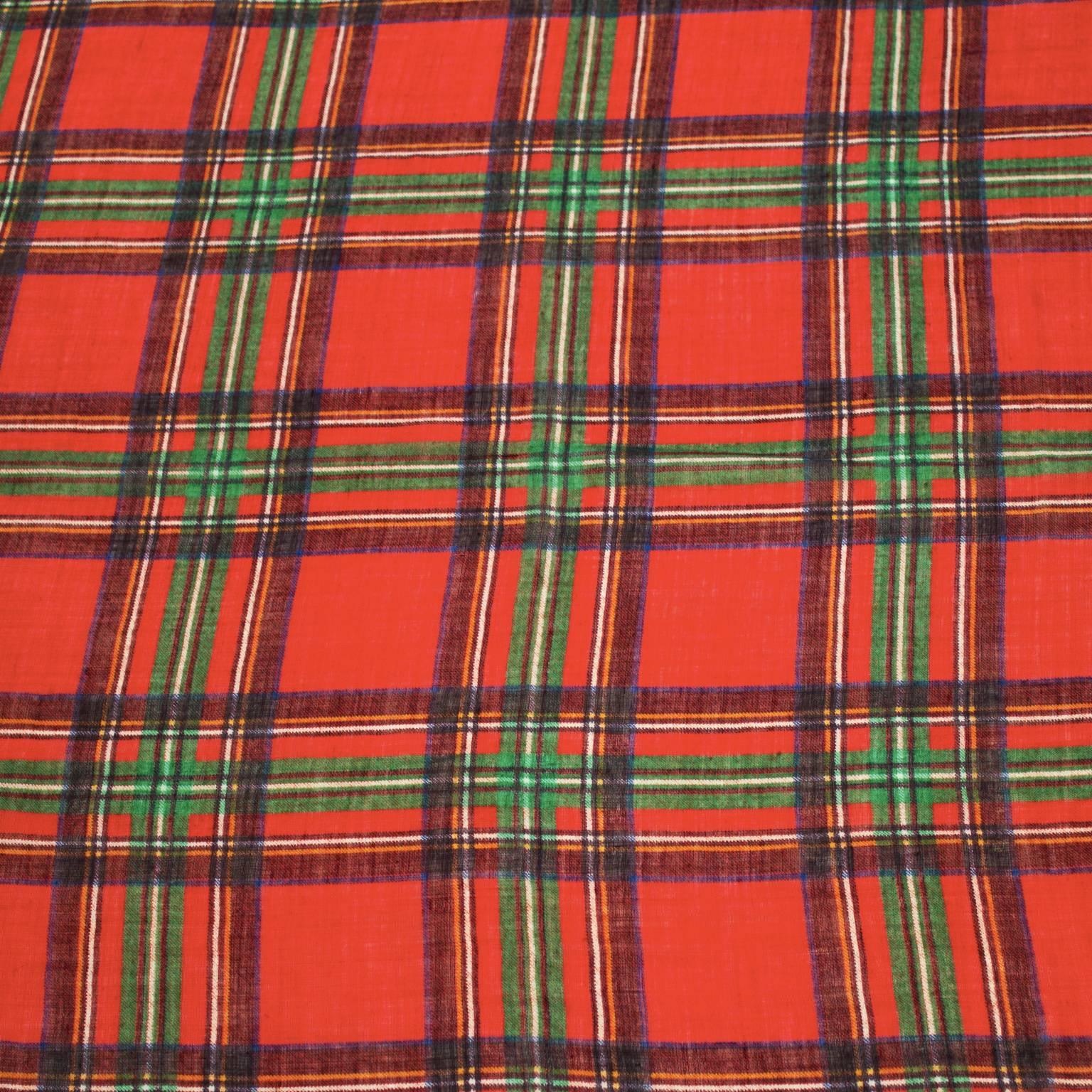 Yves Saint Laurent silk cashmere blend scarf from the 1970's. The red and green plaid scarf has a frayed edge detail and is signed with the YSL logo in the corner. In excellent condition. 