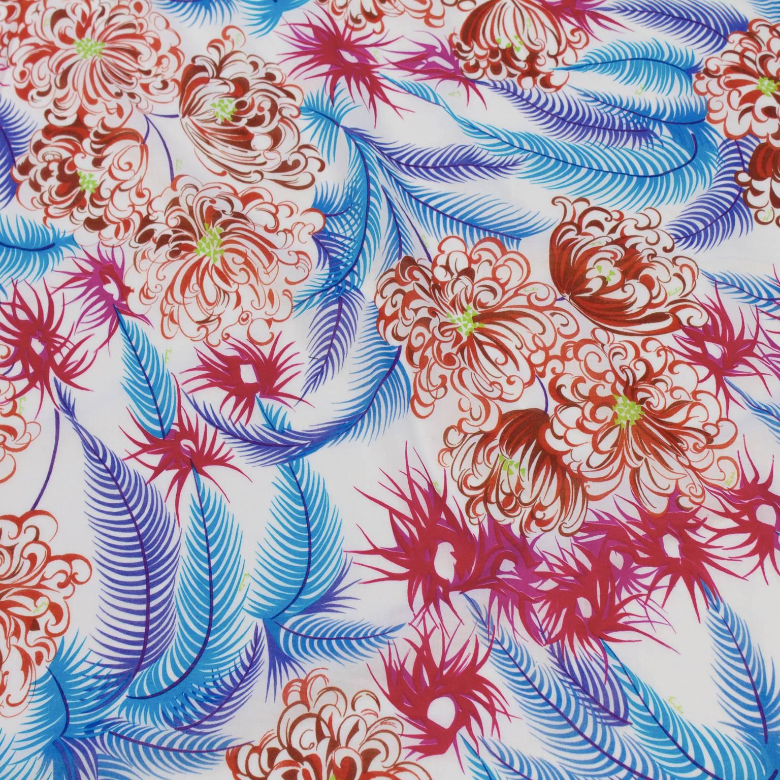 Beautiful Emilio Pucci fine guage cotton printed scarf from the 1970's. The scarf features a design of delicate purple and blue feathers with pink and brown blooms that have lime green accents. Signature throughout fabric. Perfect for the summer.