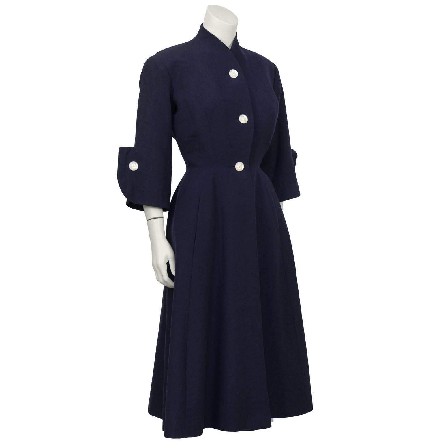Staebe-Seger navy coat dress from the 1950's. Inspired by Dior’s “New Look”, the designers Gert Staebe and Hans Seger, regarded as the haute couturiers of Germany, created their version with subtle padding above the bust as well as on the hips. 