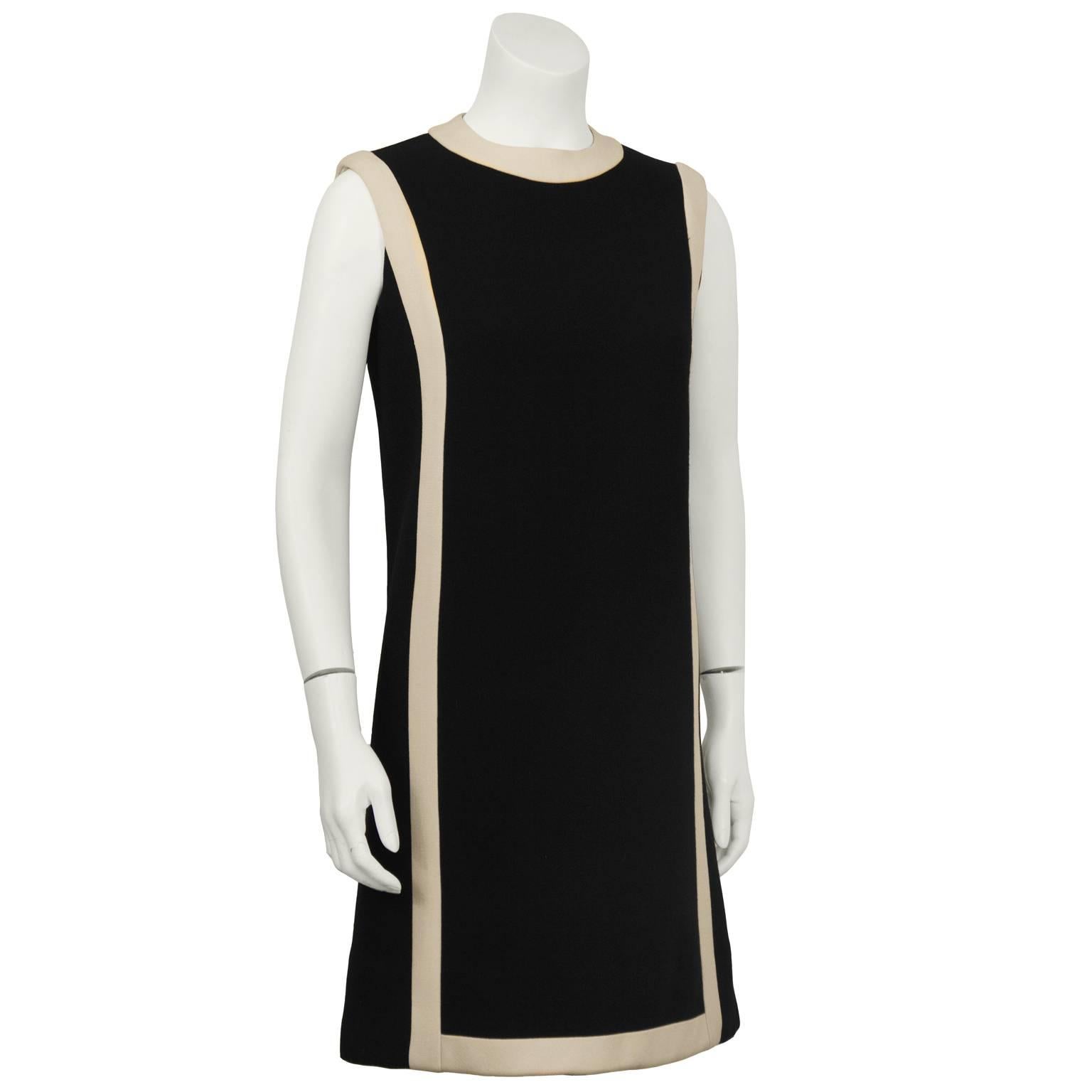 Anonymous Mod geometric black wool sleeveless shift dress. Dress features a cream band detail along the neckline and two bands which travel around the shoulder and down the front and back. Zipper at the back. Invisible repair on the front. Excellent