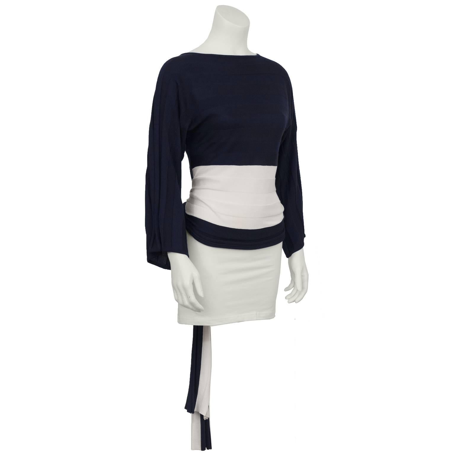 1980's ODLR navy and white sweater with horizontal ribbing, loose fitting sleeves and a tieback detail on the bottom. Excellent condition. Paired with jeans or a narrow skirt this sweater looks super modern. Fits like a US 4-6. 
