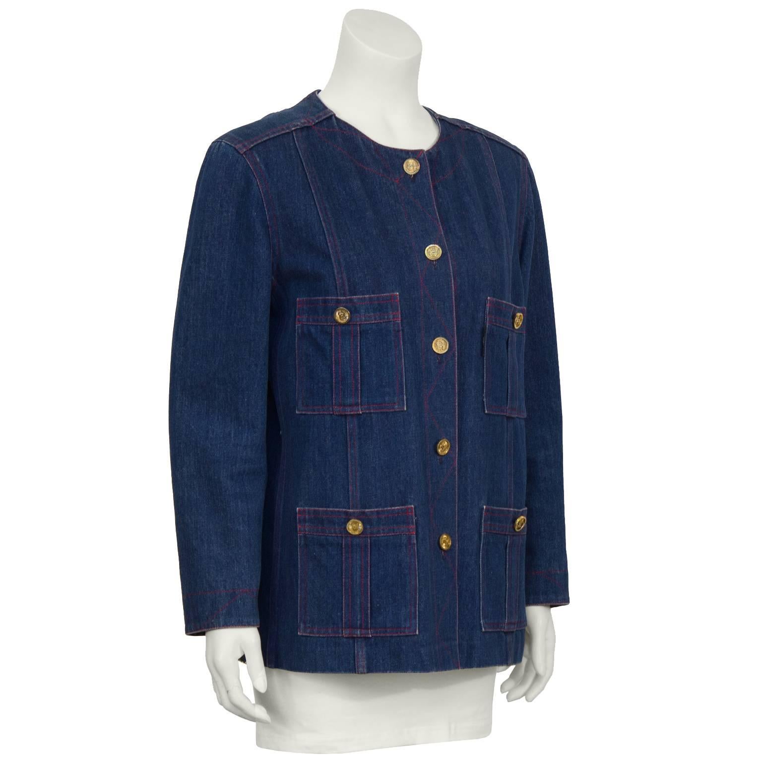 Late 1980's collarless denim jacket. The jacket is styled in the classic Chanel shape with four front patch pockets and gold CC logo buttons. Red stitching adds to the casual feel of this on-trend collectors piece. A fun take on a classic icon.